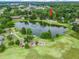 Breathtaking aerial view of home near serene lake and fountain and a lively community park with modern playground at 1630 Se 29Th Ter, Ocala, FL 34471
