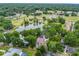 Aerial view showcasing the lush neighborhood surroundings with a pond, park, and residential area at 1630 Se 29Th Ter, Ocala, FL 34471