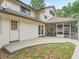 Rear view of house showing exterior door, screened lanai and mature trees at 1630 Se 29Th Ter, Ocala, FL 34471