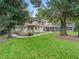 Spacious backyard with lush trees and a pristine screened pool at 1630 Se 29Th Ter, Ocala, FL 34471