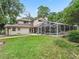 Expansive backyard with a screened-in pool and well-maintained lawn at 1630 Se 29Th Ter, Ocala, FL 34471