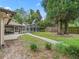 Well-maintained backyard features a walkway leading to a screened lanai, offering a serene and private outdoor space at 1630 Se 29Th Ter, Ocala, FL 34471