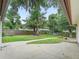 Fenced backyard with mature trees and pathway to home at 1630 Se 29Th Ter, Ocala, FL 34471