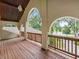 Spacious balcony with wooden railing and flooring offering scenic views of the surrounding landscape at 1630 Se 29Th Ter, Ocala, FL 34471