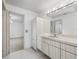 Bright bathroom with tiled floors, white cabinets, and a large countertop with an integrated sink at 1630 Se 29Th Ter, Ocala, FL 34471