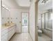 Bright bathroom with white tiled floors, a shower-tub combination, and bright vanity lighting at 1630 Se 29Th Ter, Ocala, FL 34471
