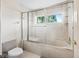 Clean bathroom features a shower-tub combination with glass sliding doors and white tile at 1630 Se 29Th Ter, Ocala, FL 34471
