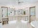 Large bathroom featuring jacuzzi tub, vanity, and tile flooring at 1630 Se 29Th Ter, Ocala, FL 34471