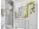 Bright bathroom featuring glass shower, vanity with storage, and decorative mirror at 1630 Se 29Th Ter, Ocala, FL 34471
