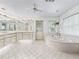 Beautiful bathroom featuring jacuzzi tub, tile flooring, and double sinks at 1630 Se 29Th Ter, Ocala, FL 34471