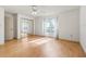 Bright bedroom with wood floors, ceiling fan, and mirrored closet at 1630 Se 29Th Ter, Ocala, FL 34471