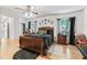 Bright bedroom with wood floors, a ceiling fan, and plenty of natural light from the two large windows at 1630 Se 29Th Ter, Ocala, FL 34471