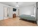 Bright bedroom features a ceiling fan, wood floors, and an ensuite bathroom at 1630 Se 29Th Ter, Ocala, FL 34471