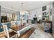 Open dining area leading to living room with statement lighting and large wood table and seating at 1630 Se 29Th Ter, Ocala, FL 34471