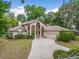 Stunning two-story home with dual balconies, a spacious driveway, mature trees, and well-maintained landscaping at 1630 Se 29Th Ter, Ocala, FL 34471