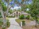 Beautiful two-story home with mature trees, dual balconies and a long patterned driveway at 1630 Se 29Th Ter, Ocala, FL 34471