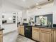 Kitchen featuring tile floors, wood cabinets, black counters, and stainless steel appliances at 1630 Se 29Th Ter, Ocala, FL 34471