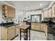 Kitchen with tile floors, wood cabinets, black counters, and stainless steel appliances at 1630 Se 29Th Ter, Ocala, FL 34471