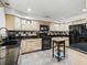 Kitchen featuring tile floors, wood cabinets, black counters, and stainless steel appliances at 1630 Se 29Th Ter, Ocala, FL 34471