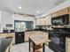 Kitchen featuring tile floors, wood cabinets, black counters, and stainless steel appliances at 1630 Se 29Th Ter, Ocala, FL 34471