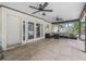 Covered patio with tile flooring, ceiling fans, and comfortable outdoor seating at 1630 Se 29Th Ter, Ocala, FL 34471