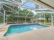 Inviting screened-in pool with tiled accents and clear water for relaxation at 1630 Se 29Th Ter, Ocala, FL 34471
