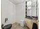 Stylish powder room with elegant black fixtures, chandelier, granite vanity, and unique tile accents at 1630 Se 29Th Ter, Ocala, FL 34471