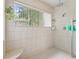White tiled shower with a window and a built in seat at 1630 Se 29Th Ter, Ocala, FL 34471
