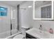 Renovated bathroom featuring a tiled shower, glass door, and a modern lighted mirror at 1636 Sw 5Th Pl, Ocala, FL 34471