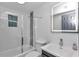 Updated bathroom with tiled shower, glass door, modern vanity, and illuminated mirror at 1636 Sw 5Th Pl, Ocala, FL 34471