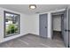 Cozy bedroom features fresh paint, wood-look floors, and natural light from updated window at 1636 Sw 5Th Pl, Ocala, FL 34471