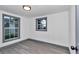 Bright bedroom featuring wood-look floors, fresh paint, and natural light from updated windows at 1636 Sw 5Th Pl, Ocala, FL 34471