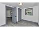 Bedroom with closet doors, light grey trim and wood-look flooring throughout the house at 1636 Sw 5Th Pl, Ocala, FL 34471