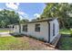 Cozy home featuring a bright blue front door, fresh landscaping, and a neatly maintained lawn at 1636 Sw 5Th Pl, Ocala, FL 34471