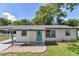 A charming home featuring a bright blue front door, complemented by well-maintained landscaping and a welcoming entrance at 1636 Sw 5Th Pl, Ocala, FL 34471