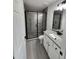 Modern bathroom showcasing granite vanity and updated glass shower at 1780 Winding Hills Rd, Dunnellon, FL 34431