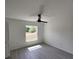 Bedroom with modern ceiling fan and window allowing ample natural light at 1780 Winding Hills Rd, Dunnellon, FL 34431