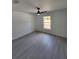 Bedroom with modern ceiling fan and window allowing ample natural light at 1780 Winding Hills Rd, Dunnellon, FL 34431