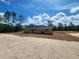 Image showing the rear of the property with fresh new sod and covered patio at 1780 Winding Hills Rd, Dunnellon, FL 34431