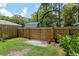 Wooden fence at the edge of backyard with a gate to another area and some greenery at 1841 Ne 38Th St, Ocala, FL 34479