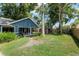 View of the backyard with a patio, a covered gazebo-like structure, trees, and a wooden fence at 1841 Ne 38Th St, Ocala, FL 34479
