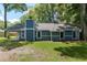 Back exterior of the home featuring a large backyard at 1841 Ne 38Th St, Ocala, FL 34479