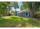 Green backyard featuring a privacy fence, gazebo, and mature trees at 1841 Ne 38Th St, Ocala, FL 34479