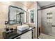 Bathroom features a unique vanity with a decorative mirror and a modern tiled shower with glass doors at 1841 Ne 38Th St, Ocala, FL 34479