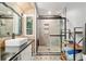 Charming bathroom with wood paneled walls, vessel sink, and a modern shower with mosaic tile and sleek glass doors at 1841 Ne 38Th St, Ocala, FL 34479
