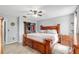 Spacious primary bedroom with a king-sized bed, ceiling fan, walk-in closet and wood flooring at 1841 Ne 38Th St, Ocala, FL 34479