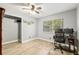 Bright bedroom featuring hardwood floors, a closet, a window with a view, and a functional desk area at 1841 Ne 38Th St, Ocala, FL 34479