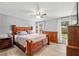 Primary bedroom with a king-sized bed, wood flooring, ceiling fan and natural light at 1841 Ne 38Th St, Ocala, FL 34479