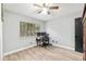 Neutral bedroom with hardwood floors, a window with blinds, and a desk area perfect for work or study at 1841 Ne 38Th St, Ocala, FL 34479