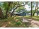 Exterior of charming home featuring a blue exterior, lush landscaping, and mature trees for added privacy at 1841 Ne 38Th St, Ocala, FL 34479